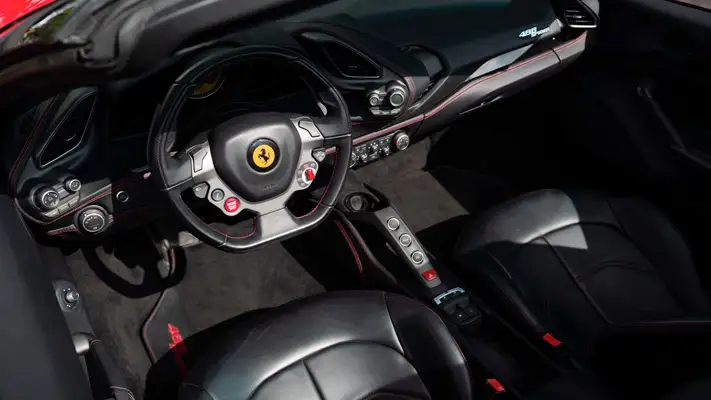 Red on black Ferrari 488 Spider for rent miami dashboard view mph club