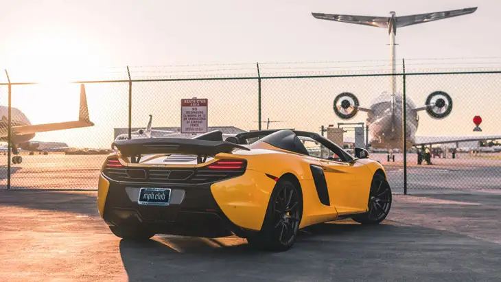 Yellow McLaren 650s Spider rental rszd view mph club