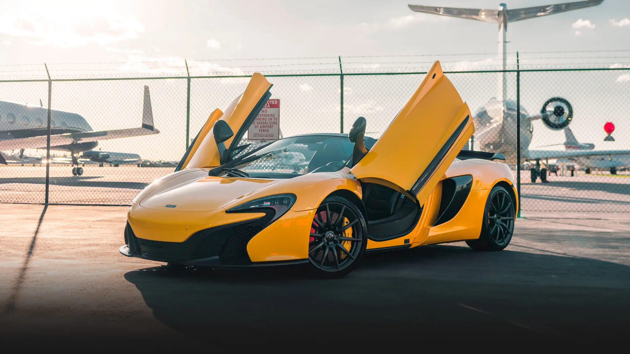 Yellow McLaren 650s Spider rental profile view mph club