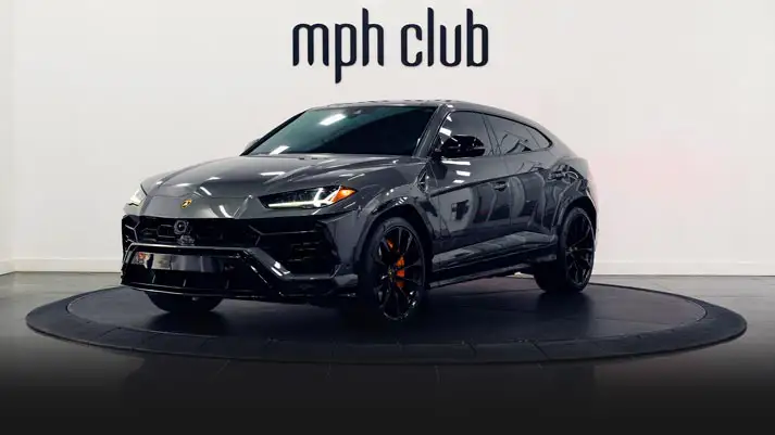 Grey on orange Lamborghini Urus for rent Miami profile view rszd - mph club